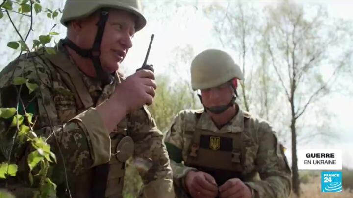 Ukrainian military specialists clearing mines left behind by Russian forces in the Ukrainian countryside. 